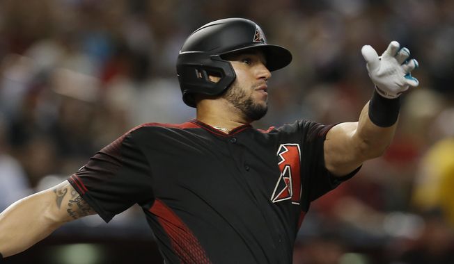 FILE - In this Aug. 17, 2019 file photo Arizona Diamondbacks&#x27; David Peralta hits against the San Francisco Giants in the first inning of a baseball game in Phoenix. The Diamondbacks have finalized a $22 million, three-year contract with Peralta that runs through 2022, Monday, Jan. 13, 2020. (AP Photo/Rick Scuteri, file)