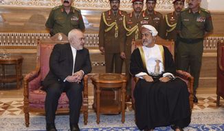 In this Sunday, Jan. 12, 2020 photo, made available by the Oman News Agency, Oman&#39;s new Sultan Haitham bin Tariq Al Said, right, receives Iranian Foreign Minister Javad Zarif, after his arrival to attend an official mourning ceremony for the late Sultan Qaboos, in Muscat, Oman. A flurry of diplomatic visits and meetings crisscrossing the Persian Gulf are driving urgent efforts to defuse the possibility of all-out war after the U.S. killed Iran&#39;s top military commander. Global leaders and top diplomats are repeating in recent days the mantra of “de-escalation” and “dialogue,” yet none have publicly laid out a path to achieving either. (Oman News Agency via AP)