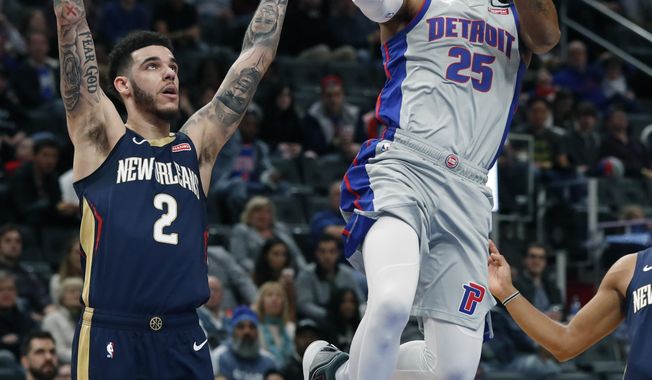 Detroit Pistons guard Derrick Rose (25) attempts a layup as New Orleans Pelicans guard Lonzo Ball (2) defends during the first half of an NBA basketball game, Monday, Jan. 13, 2020, in Detroit. (AP Photo/Carlos Osorio)
