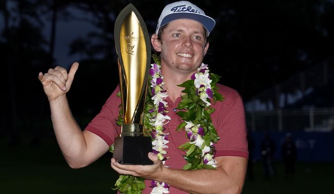 Cameron Smith holds the champions trophy after the final round of the Sony Open PGA Tour golf event, Sunday, Jan. 12, 2020, at Waialae Country Club in Honolulu. (AP Photo/Matt York)