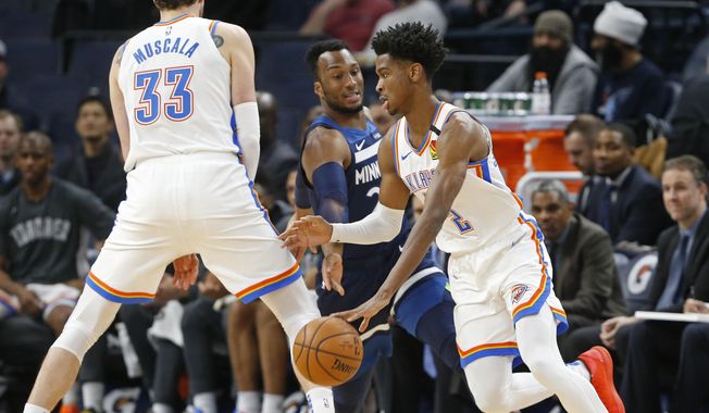 Oklahoma City Thunder&#x27;s Mike Muscala, left, sets a pick for Shai Gilgeous-Alexander, right, of Canada as he drives past Minnesota Timberwolves&#x27; Josh Okogie of Nigeria in the first half of an NBA basketball game Monday, Jan. 13, 2020, in Minneapolis. (AP Photo/Jim Mone)