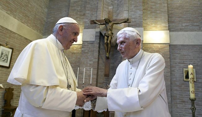 In this June 28, 2017, file photo, Pope Francis, left, and Pope Benedict XVI, meet each other on the occasion of the elevation of five new cardinals at the Vatican. Retired Pope Benedict XVI has broken his silence to reaffirm the value of priestly celibacy, co-authoring a bombshell book at the precise moment that Pope Francis is weighing whether to allow married men to be ordained to address the Catholic priest shortage. (L&#x27;Osservatore Romano/Pool photo via AP, File) **FILE**