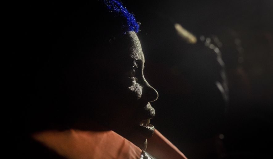 Wealth Peter, from Nigeria, reacts after being rescued from an overcrowded rubber boat in the Mediterranean Sea, by aid workers of the Spanish NGO Open Arms, international waters, off the Libyan coast, Friday, Jan. 10, 2020. (AP Photo/Santi Palacios)