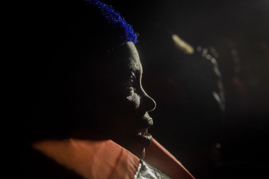 Wealth Peter, from Nigeria, reacts after being rescued from an overcrowded rubber boat in the Mediterranean Sea, by aid workers of the Spanish NGO Open Arms, international waters, off the Libyan coast, Friday, Jan. 10, 2020. (AP Photo/Santi Palacios)