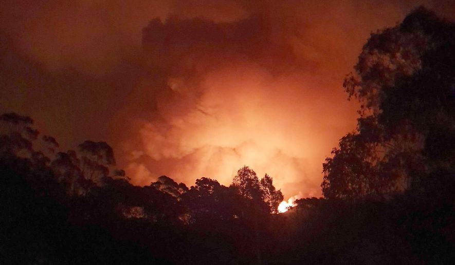 In this Dec. 31, 2019, photo provided by Siobhan Threlfall, a fire approaches the village of Nerrigundah, Australia. The tiny village has been among the hardest hit by Australia's devastating wildfires, with about two thirds of the homes destroyed and a 71-year-old man killed. (AP Photo/Siobhan Threlfall)