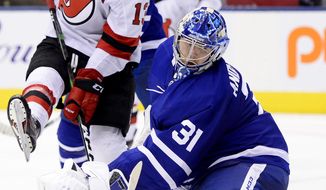 Toronto Maple Leafs goaltender Frederik Andersen (31) looks back as the puck goes in, next to New Jersey Devils center Nico Hischier (13) during the third period of an NHL hockey game Tuesday, Jan. 14, 2020, in Toronto. (Frank Gunn/The Canadian Press via AP)