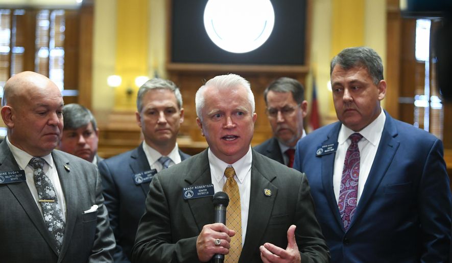 New state Sen. Randy Robertson, R-Cataula, center, is flanked by Majority Leader Mike Dugan, R-Carrollton, left, and Majority Whip Steve Gooch, R-Dahlonega, right, as he speaks to the media during the opening day of the year for the general session of the state legislature, Monday, Jan. 13, 2020, in Atlanta. (AP Photo/John Amis)