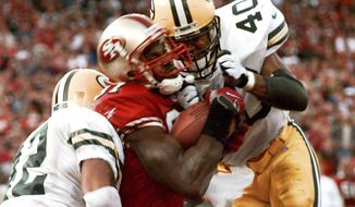 FILE - In this Jan. 3, 1999, file photo, San Francisco 49ers&#39; wide receiver Terrell Owens pulls in a 25-yard touchdown pass from quarterback Steve Young as Green Bay Packers&#39; safeties Pat Terrell (40) and Darren Sharper defend late in the fourth quarter of an NFC wild card playoff game at 3COM Park in San Francisco. Owens&#39; catch with three seconds left in the game led the 49ers to a 30-27 win. The two teams that have combined for nine Super Bowl titles will meet with a spot in the ultimate game on the line once again when the 49ers (14-3) host the Packers (14-3) in the NFC championship game on Sunday, Jan. 19, 2020. (AP Photo/Susan Ragan) ** FILE **