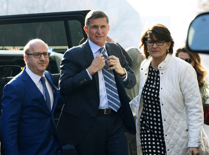 In this Dec. 1, 2017, file photo, Michael Flynn, center, arrives at federal court in Washington.  (AP Photo/Susan Walsh, File) **FILE**