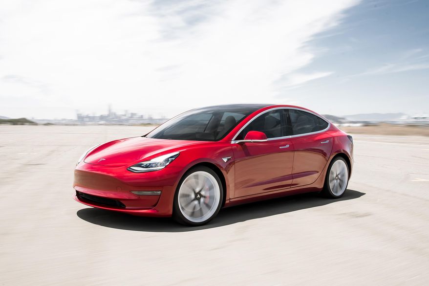 This undated photo provided by Tesla shows the 2019 Model 3. The Model 3 is the most affordable and fun-to-drive Tesla that you can buy right now. In many ways the Model 3 also betters established luxury sedans such as the BMW 3 Series.  (James Lipman/Tesla Motors via AP)