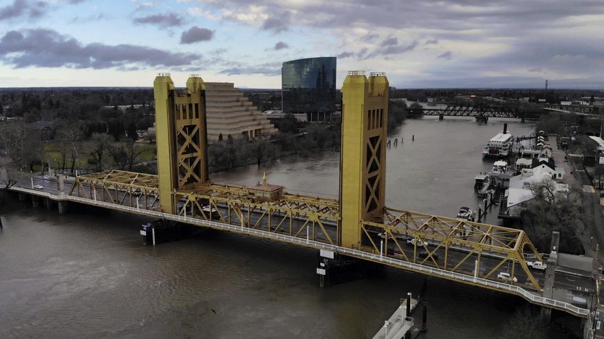 FILE - In this Feb. 14, 2019, file photo the Sacramento River flows under the Tower Bridge in Sacramento, Calif. California Gov. Gavin Newsom's administration officially restarted a project on Wednesday, Jan. 15, 2020, that would divert water from the San Joaquin Delta and send it to Southern California. (Hector Amezcua/The Sacramento Bee via AP, File)