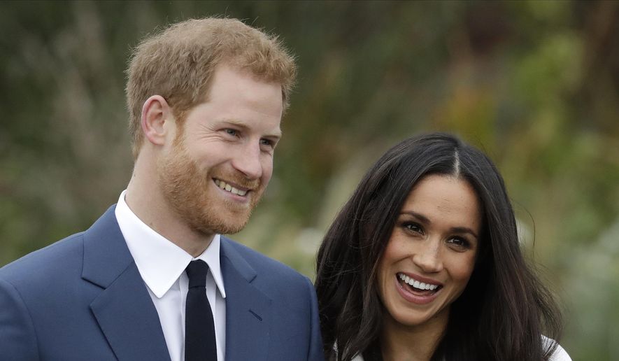 In this Monday, Nov. 27, 2017, file photo, Britain&#39;s Prince Harry and his then-fiancee Meghan Markle pose for photographers during a photocall in the grounds of Kensington Palace in London. (AP Photo/Matt Dunham, File)
