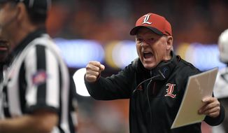 FILE - In this Nov. 9, 2018, file photo, Louisville head coach Bobby Petrino tries to get the referees attention during the first half of an NCAA college football game against Syracuse, in Syracuse, N.Y. Petrino, a coach with a track record of on-the-field success but off-the-field embarrassments, will be the next coach at Missouri State, the university said Wednesday, Jan. 15, 2020. (AP Photo/Adrian Kraus, File)