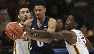 Penn State&#39;s Myreon Jones protects the ball against Minnesota&#39;s Payton Willis, left, and Marcus Carr, right, during an NCAA basketball game Wednesday, Jan. 15, 2020, in Minneapolis. (AP Photo/Stacy Bengs)