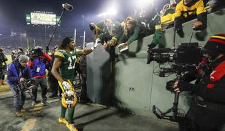 Green Bay Packers&#x27; Davante Adams celebrates with fans after an NFL divisional playoff football game against the Seattle Seahawks Sunday, Jan. 12, 2020, in Green Bay, Wis. The Packers won 28-23 to advance to the NFC Championship. (AP Photo/Mike Roemer)
