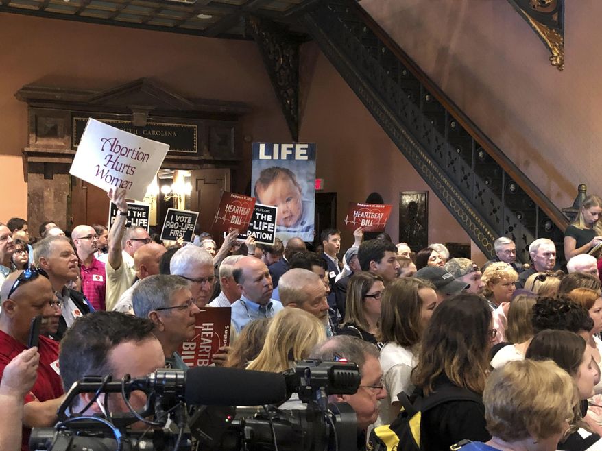 Supporters of a bill that would ban nearly all abortions in South Carolina fill the Statehouse lobby for a rally on Wednesday, Jan. 15, 2020, in Columbia, South Carolina. The supporters of the heartbeat bill want Senators to vote on the proposal, while Senate leaders said they don't have the votes and it would bog down other debates. (AP Photo/Jeffrey Collins)