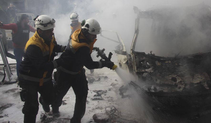 This photo provided by the Syrian Civil Defense White Helmets, which has been authenticated based on its contents and other AP reporting, shows Syrian White Helmet civil defense workers extinguish a burning car that was hit by Syrian government airstrikes, in Idlib province, Syria, Wednesday, Jan. 15, 2020. Syrian government warplanes struck a market and an industrial area on Wednesday in the last territory in the hands of rebel groups in the country&#39;s northwest, killing at least 15 people, opposition activists said. (Syrian Civil Defense White Helmets via AP)