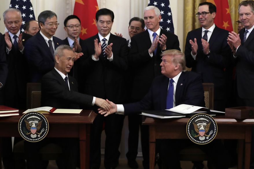 President Donald Trump shakes hands with Chinese Vice Premier Liu He, after signing a trade agreement in the East Room of the White House, Wednesday, Jan. 15, 2020, in Washington. (AP Photo/Evan Vucci)