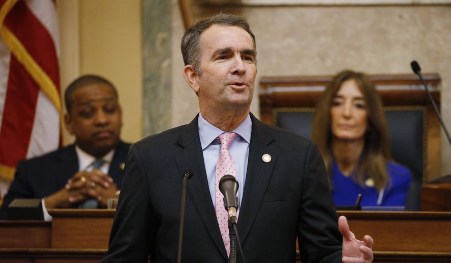 In this Jan. 8, 2020, file photo, Virginia Gov. Ralph Northam, center, gestures as he delivers his State of the Commonwealth address as House Speaker Eileen Filler-Corn, D-Fairfax, right, and Lt. Gov. Justin Fairfax, left, listen before a joint session of the Virginia Assembly at the state Capitol in Richmond, Va. (AP Photo/Steve Helber, File) ** FILE **