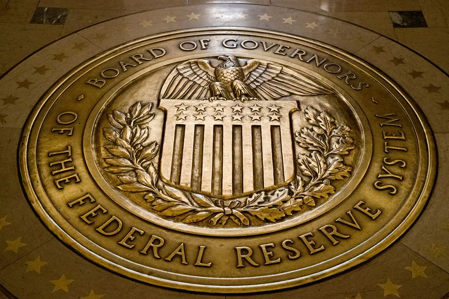 FILE - This Feb. 5, 2018, file photo shows the seal of the Board of Governors of the United States Federal Reserve System in the ground at the Marriner S. Eccles Federal Reserve Board Building in Washington. Economist Judy Shelton, tapped by President Donald Trump for a seat on the Federal Reserve board, says she does not favor credit tightening by the Federal Reserve that would harm investors. In a CNBC interview on Friday, July 5, 2019, Shelton sought to align her past criticism of the Fed’s record low interest rates during the Obama administration with the current attacks by Trump on Fed rate hikes.(AP Photo/Andrew Harnik, File)
