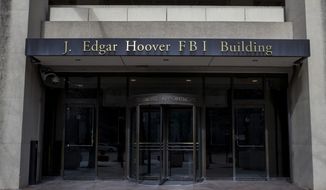 In this March 4, 2019, file photo, the J. Edgar Hoover FBI Building is seen in Washington. (AP Photo/Alex Brandon, File) **FILE**