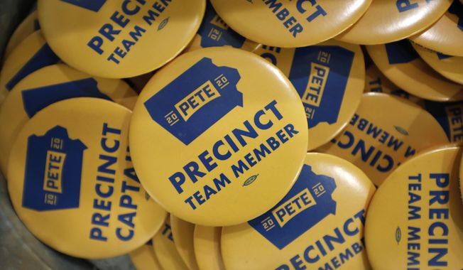 FILE - In this Jan. 9, 2020, file photo, precinct team member buttons are seen during a caucus training meeting at the local headquarters for Democratic presidential candidate former South Bend, Ind., Mayor Pete Buttigieg, in Ottumwa, Iowa. (AP Photo/Charlie Neibergall)
