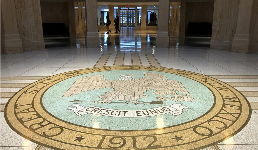Visitors trickle into the New Mexico state Capitol building in Santa Fe, N.M., on Thursday, Jan. 16, 2020, as lawmakers prepare for a 30 legislative session. Gov. Michelle Lujan Grisham says she'll consider red-flag gun legislation, proposals to legalize recreational marijuana and new incentives for localized renewable energy installations electric car purchases. Spending increases are proposed for K-12 education, early childhood programs, tuition-free college and more amid a budget surplus. (AP Photo/Morgan Lee)