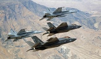 F-35C Lightning IIs, attached to the Grim Reapers of Strike Fighter Squadron (VFA) 101, and F/A-18E/F Super Hornets attached to the Naval Aviation Warfighter Development Center (NAWDC) fly over Naval Air Station Fallon&#39;s (NASF) Range Training Complex near Fallon, Nevada, Sept. 3, 2015. (Lt. Cmdr. Darin Russell/U.S. Navy via AP) ** FILE ** 