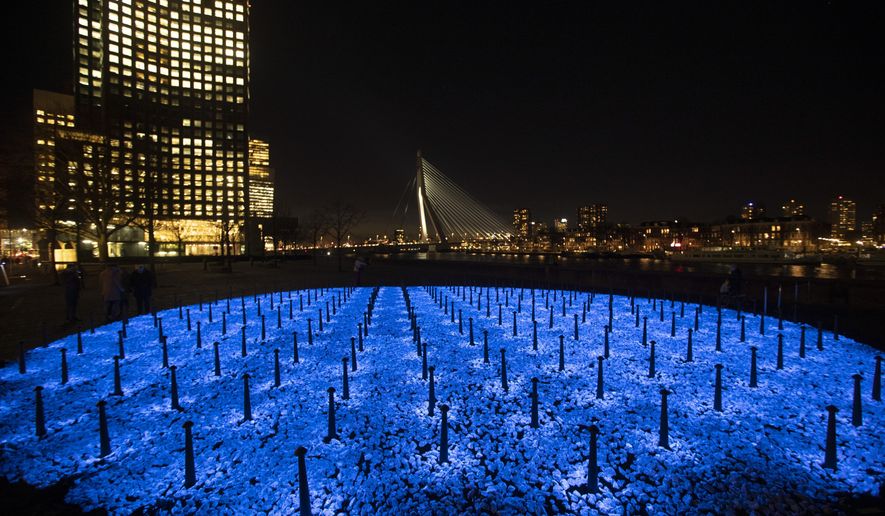 The monument Levenslicht, or Light of Life, by artist Daan Roosegaarde, consisting of 104,000 light-emitting stones for the number of Dutch Holocaust victims is unveiled in Rotterdam, Netherlands, Thursday, Jan. 16, 2020, to mark the 75th anniversary, later this month, of the liberation of Auschwitz concentration and extermination camp. (AP Photo/Peter Dejong)