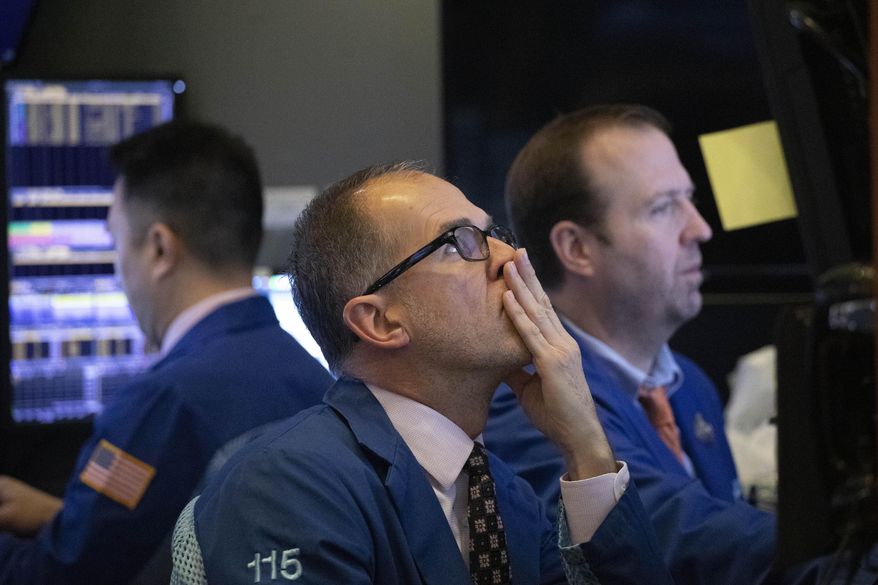 FILE - In this Jan. 2, 2020, file photo traders monitor stock prices at the New York Stock Exchange. Over the next few weeks, companies across the country will be telling investors how much profit they made in the last three months of 2019. (AP Photo/Mark Lennihan, File)