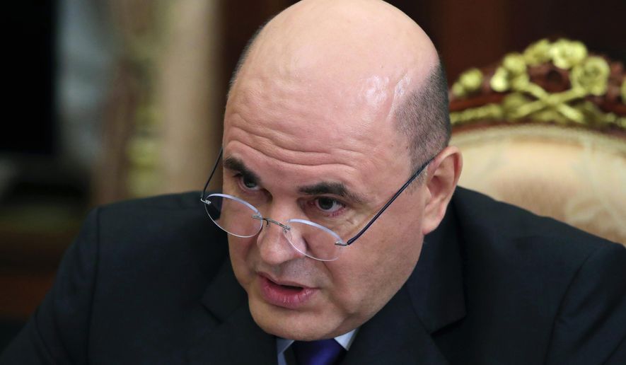 In this photo taken on Thursday, Nov. 21, 2019, Russian Tax Service chief Mikhail Mishustin speaks to Russian President Vladimir Putin during their meeting in the Kremlin in Moscow, Russia. Putin has on Wednesday, Jan. 15, 2020 named Tax Service chief Mikhail Mishustin as Russia's new prime minister. The 53-year-old Mishustin has worked in the government since 1998. Mishustin has a kept low profile while serving as the head of the Federal Tax Service since 2010. (Mikhail Klimentyev, Sputnik, Kremlin Pool Photo via AP, File)