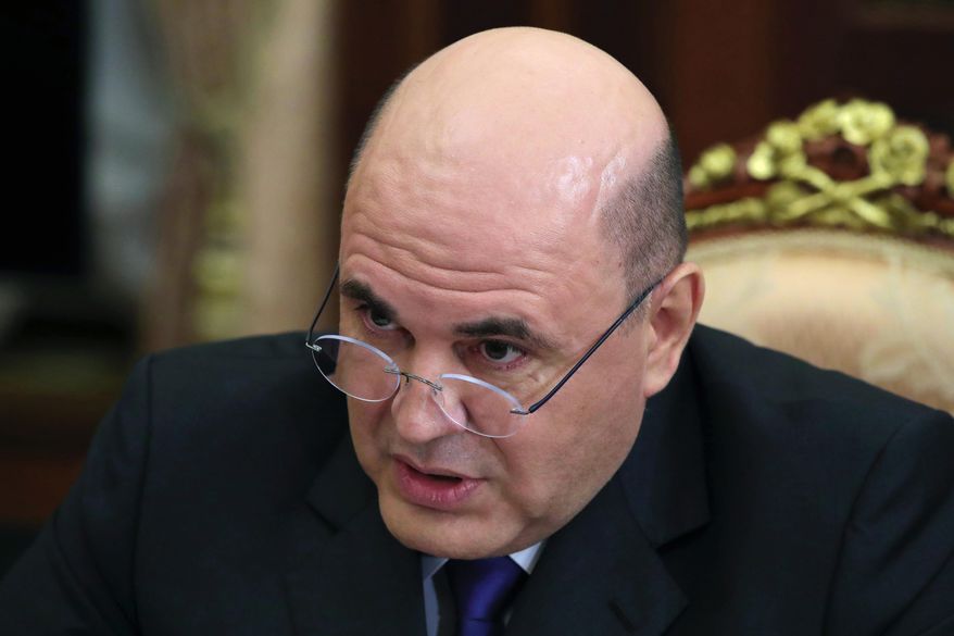 In this photo taken on Thursday, Nov. 21, 2019, Russian Tax Service chief Mikhail Mishustin speaks to Russian President Vladimir Putin during their meeting in the Kremlin in Moscow, Russia. Putin has on Wednesday, Jan. 15, 2020 named Tax Service chief Mikhail Mishustin as Russia's new prime minister. The 53-year-old Mishustin has worked in the government since 1998. Mishustin has a kept low profile while serving as the head of the Federal Tax Service since 2010. (Mikhail Klimentyev, Sputnik, Kremlin Pool Photo via AP, File)