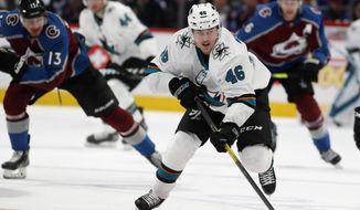 San Jose Sharks center Joel Kellman, front, drives down the ice with the puck with Colorado Avalanche right wing Valeri Nichushkin, back left, and defenseman Erik Johnson in pursuit during the second period of an NHL hockey game Thursday, Jan. 16, 2020, in Denver. (AP Photo/David Zalubowski)