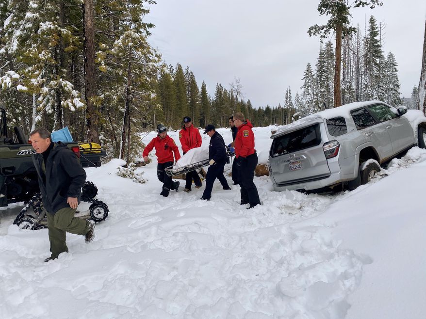 In this photo provided by the Butte County Sheriff's Department, members of the Butte County Sheriff's Search and Rescue team transport 68-year-old Paula Beth, Wednesday, Jan. 15, 2020, in Butte Meadows, Calif. Beth, who has dementia and went missing six days earlier, was discovered alive in her snowbound sports utility vehicle, about 200 miles (322 kilometers) northeast of San Francisco. (Courtesy of Butte County Sheriff's Department via AP)