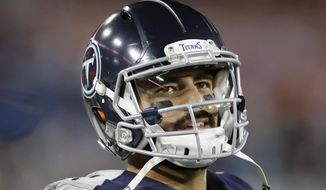 FILE - In this Nov. 24, 2019, file photo, Tennessee Titans quarterback Marcus Mariota looks at the scoreboard in the second half of an NFL football game against the Jacksonville Jaguars in Nashville, Tenn. The Tennessee Titans benched Mariota for Ryan Tannehill in mid-October after a 2-4 start. (AP Photo/James Kenney, File)