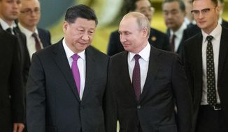 In this June 5, 2019, file photo, Russian President Vladimir Putin, center right, and Chinese President Xi Jinping, center left, enter a hall for the talks in the Kremlin in Moscow, Russia. (AP Photo/Alexander Zemlianichenko, Pool, File)