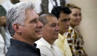 Cuba&#39;s President Miguel Diaz-Canel, left, attends a meeting in an art school during a tour in Las Tunas, Cuba, Thursday, Jan. 16, 2020. (AP Photo/Ismael Francisco)