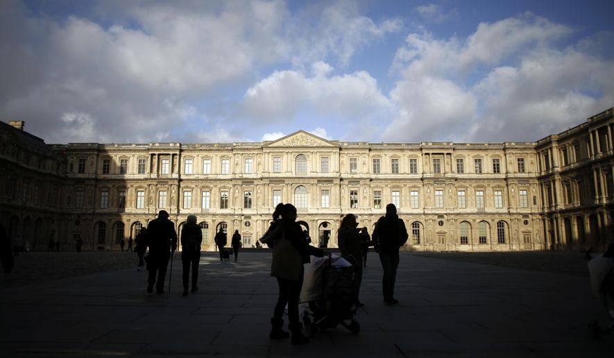 Tourists walk in the courtyard of the Louvre museum, in Paris, Friday, Dec. 13, 2019. Ongoing nationwide strikes have dented profits at Paris stores and restaurants, but tourists from around the world have continued to visit the City of Light as the holiday season approaches, according to the Paris tourism office. (AP Photo/Thibault Camus)