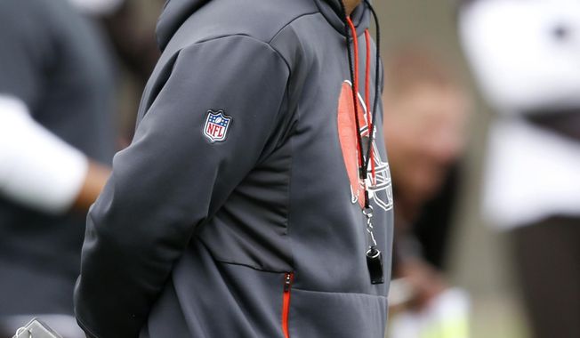 FILE - In this May 22, 2019, file photo, Cleveland Browns offensive coordinator Todd Monken watches a drill during an NFL football organized team activity session at the team&#x27;s training facility in Berea, Ohio. Todd Monken, the former offensive coordinator for the Cleveland Browns and Tampa Bay Buccaneers, is Kirby Smart&#x27;s choice to lead Georgia&#x27;s offense. Monken was named on Friday, Jan. 17, 2020, to replace James Coley as the Bulldogs&#x27; offensive coordinator. Coley will remain on staff as assistant head coach.(AP Photo/Ron Schwane, File)