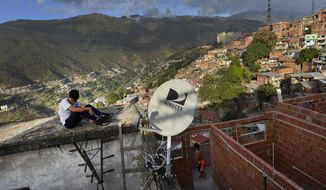A DirectTV dish stands on home in the Catia neighborhood of Caracas, Venezuela, Thursday, Jan. 9, 2020. Venezuelan President Maduro’s opponents want AT&amp;amp;T’s DirecTV unit to restore a number of channels it was required to take down from its lineup. But forcing AT&amp;amp;T to do the political bidding of Maduro’s foes could lead to retaliation and likely exit from a market where it has a whopping 44% market share. (AP Photo/Matias Delacroix)
