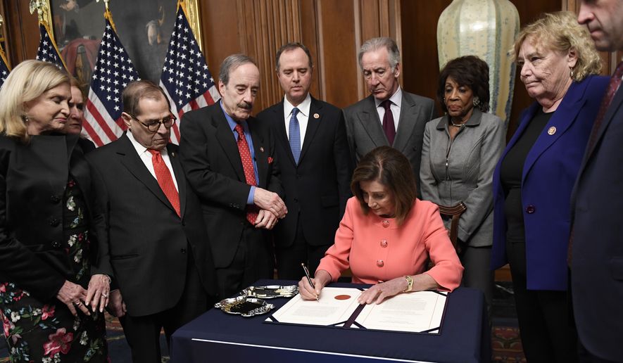 In this Jan. 15, 2020 file photo, House Speaker Nancy Pelosi of Calif., signs the resolution to transmit the two articles of impeachment against President Donald Trump to the Senate for trial on Capitol Hill in Washington.Pelosi  is surrounded by, from left, House Oversight and Government Reform Committee Chair Rep. Carolyn Maloney, D-N.Y., Rep. Sylvia Garcia, D-Texas, House Judiciary Committee Rep. Jerrold Nadler, D-N.Y., House Foreign Affairs Committee Chairman Rep. Eliot Engel, D-N.Y., House Intelligence Committee Chairman Adam Schiff, D-Calif., House Ways and Means Committee Chairman Rep. Richard Neal, D-Mass., House Financial Services Committee Chairwoman Maxine Waters, D-Calif., Rep. Zoe Lofgren, D-Calif., and Rep. Jason Crow, D-Colorado.  House Democrats were preparing to outline their case for removing Trump from office in a legal brief due Saturday, Jan. 18, as opposing sides in the impeachment case look ahead to the opening of the historic trial in the Senate.(AP Photo/Susan Walsh) **FILE**