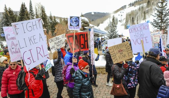 People participate in the Women&#x27;s March in Vail, Colo., Saturday, Jan. 18, 2020. Thousands gathered in cities across the country Saturday as part of the nationwide Women&#x27;s March rallies focused on issues such as climate change, pay equity, reproductive rights and immigration. (Chris Dillmann/Vail Daily via AP)