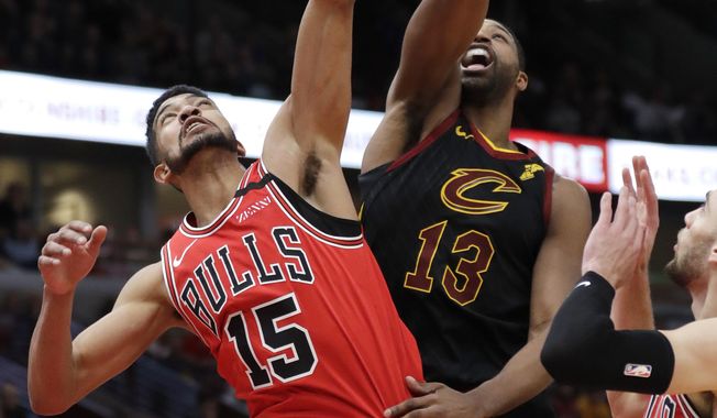 Chicago Bulls forward Chandler Hutchison, left, pulls down a rebound next to Cleveland Cavaliers&#x27; Tristan Thompson during the second half of an NBA basketball game in Chicago, Saturday, Jan. 18, 2020. The Bulls won 118-116. (AP Photo/Nam Y. Huh)