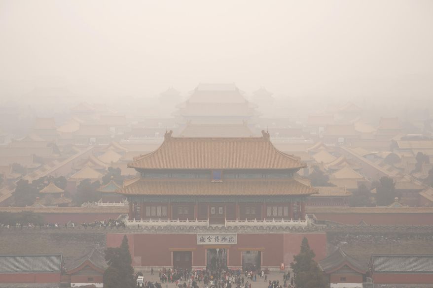 Tourists exit the Forbidden City in Beijing, Saturday, Jan. 18, 2020. A Chinese woman sparked social media outrage in her country by posting photos of herself and a friend with a Mercedes-Benz SUV on the grounds of Beijing's landmark Forbidden City, prompting an apology from the management of China's former imperial palace. (AP Photo/Mark Schiefelbein)