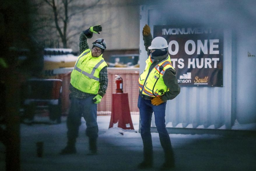 In this photo taken Jan. 10, 2020, Vanilla Ice's "Ice Ice Baby" blares as construction workers at the Rushmore Plaza Civic Center construction project in Rapid City, S.D., stretch before working. (Adam Fondren/Rapid City Journal via AP)