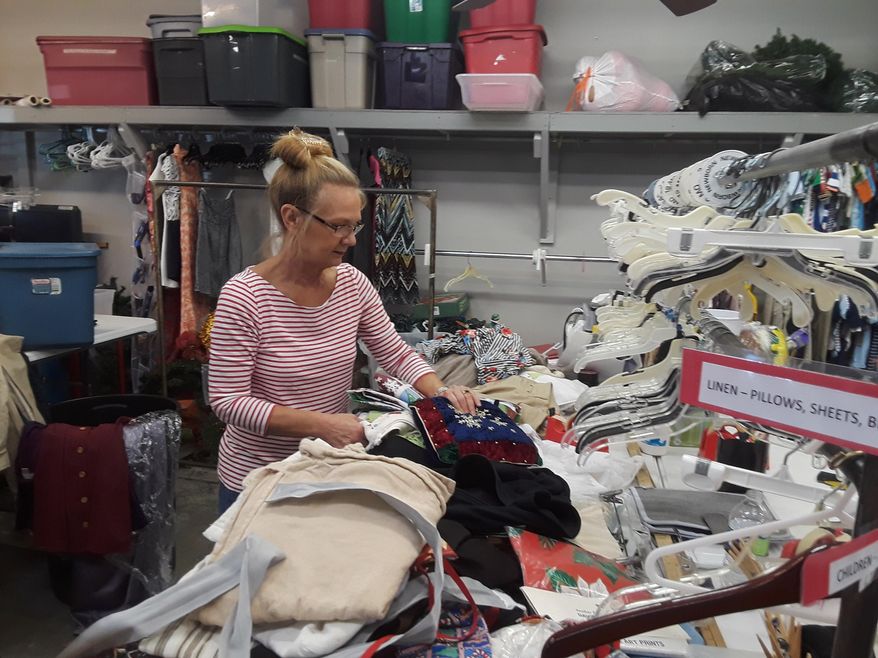 In this undated photo, volunteer worker Wanda Percle sorts donations at Gym Dandy, Thibodaux, La.'s oldest thrift store. (Dan Copp/The Houma Courier via AP)