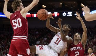 Nebraska guard Dachon Burke Jr. (11) loses the ball as he is defended by Indiana&#x27;s Joey Brunk (50) and Armaan Franklin (2) in the second half of an NCAA college basketball game Saturday, Jan. 18, 2020, in Lincoln, Neb. (Francis Gardler/Lincoln Journal Star via AP)