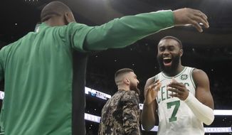 Boston Celtics guard Jaylen Brown (7) celebrates with teammate Kemba Walker in the second half of an NBA basketball game against the Detroit Pistons, Friday, Dec. 20, 2019, in Boston. (AP Photo/Elise Amendola)