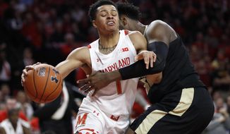 Maryland guard Anthony Cowan Jr. (1) drives against Purdue forward Trevion Williams during the first half of an NCAA college basketball game, Saturday, Jan. 18, 2020, in College Park, Md. (AP Photo/Julio Cortez)