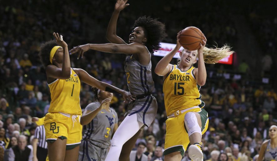 Baylor forward Lauren Cox, right, pulls down a rebound over West Virginia center Blessing Ejiofor, center, in the first half of an NCAA college basketball game, Saturday, Jan. 18, 2020, in Waco, Texas. (AP Photo/Rod Aydelotte)